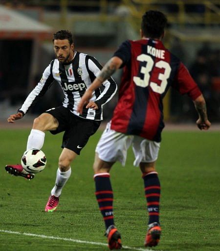 Claudio Marchisio (L) fights for bal with Kone Panagiotis on March 16, 2013 in Bologna